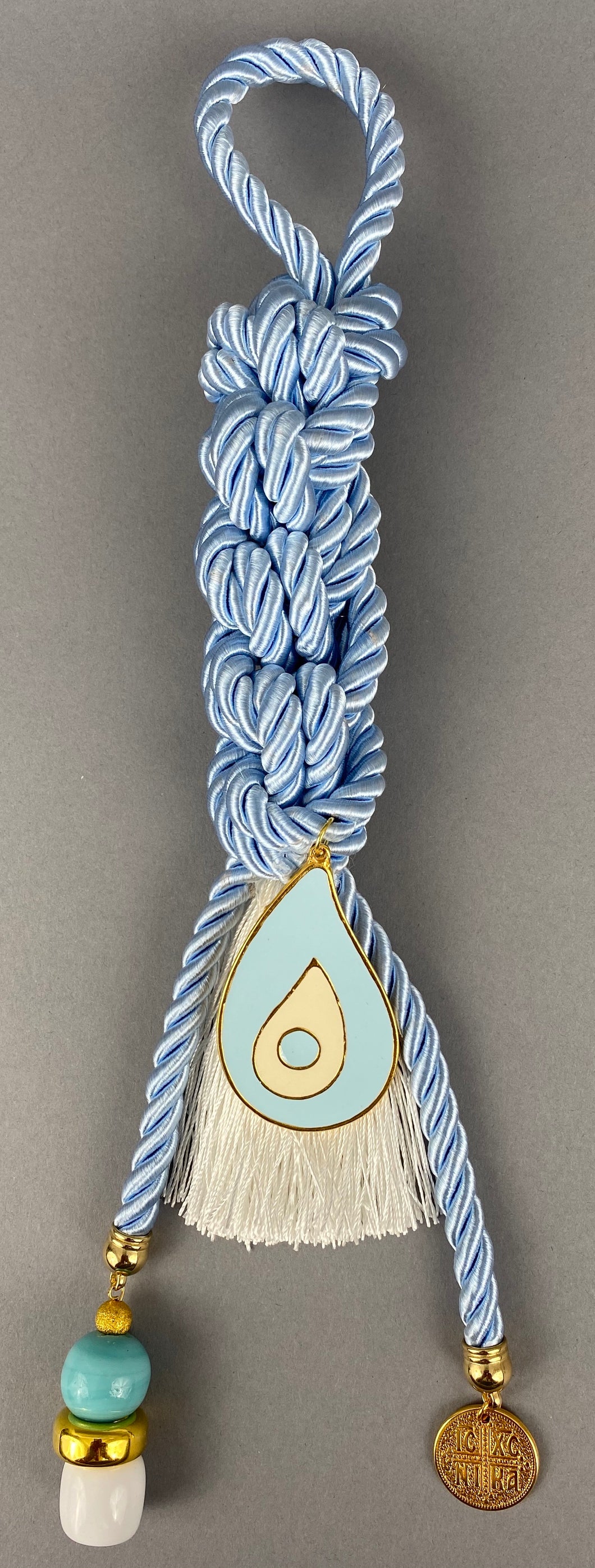Gouri 1002 Pearl Baby Blue Cord Gouri, large metal Mati, double sided  Konstantinata  pendant, large beads and white Tassel.  Measures 13.5” in length.